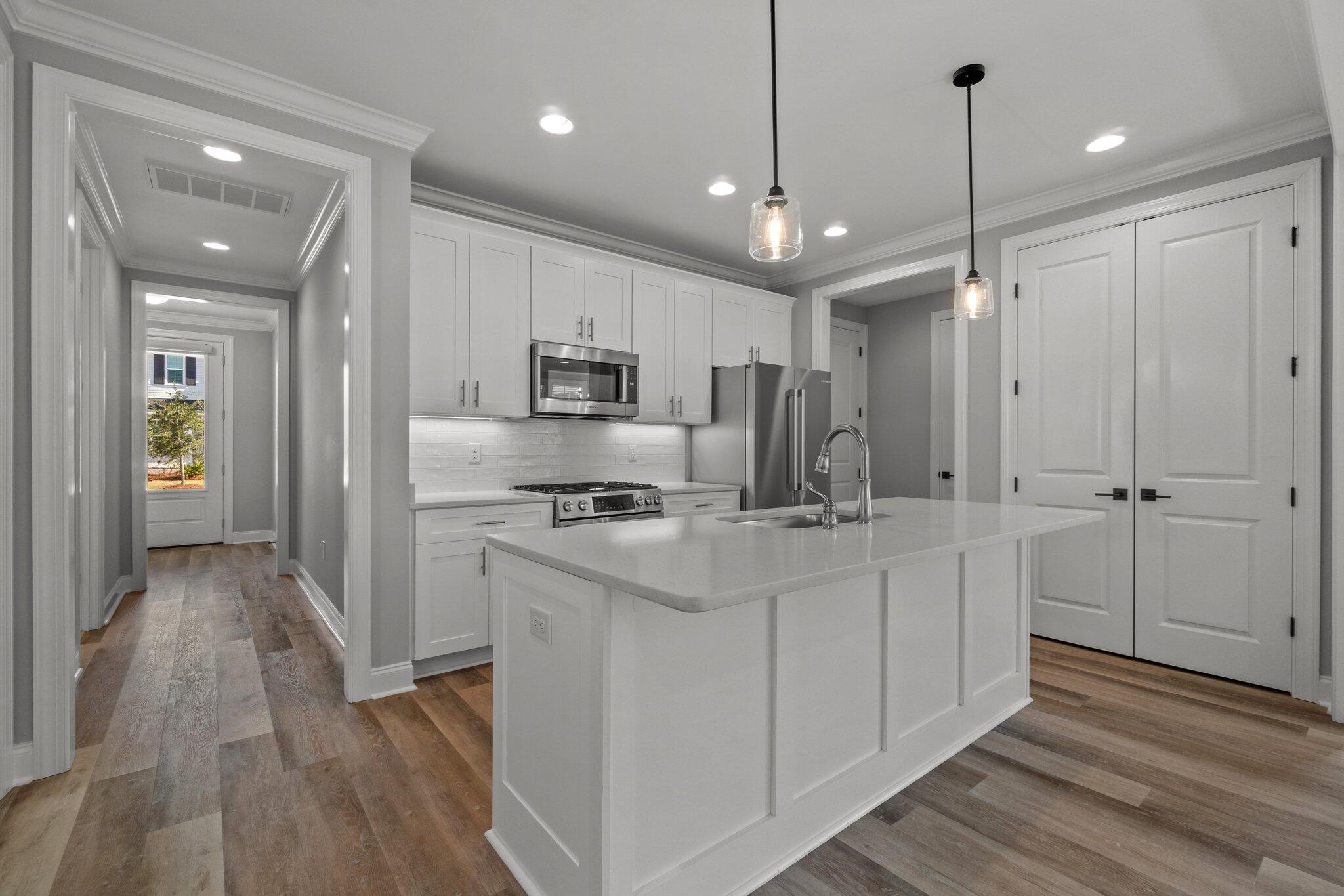 76 Conifer Ct Inlet Beach Inlet Beach, FL 32461 - Photo 5 of 25 a kitchen with kitchen island a sink stainless steel appliances and cabinets