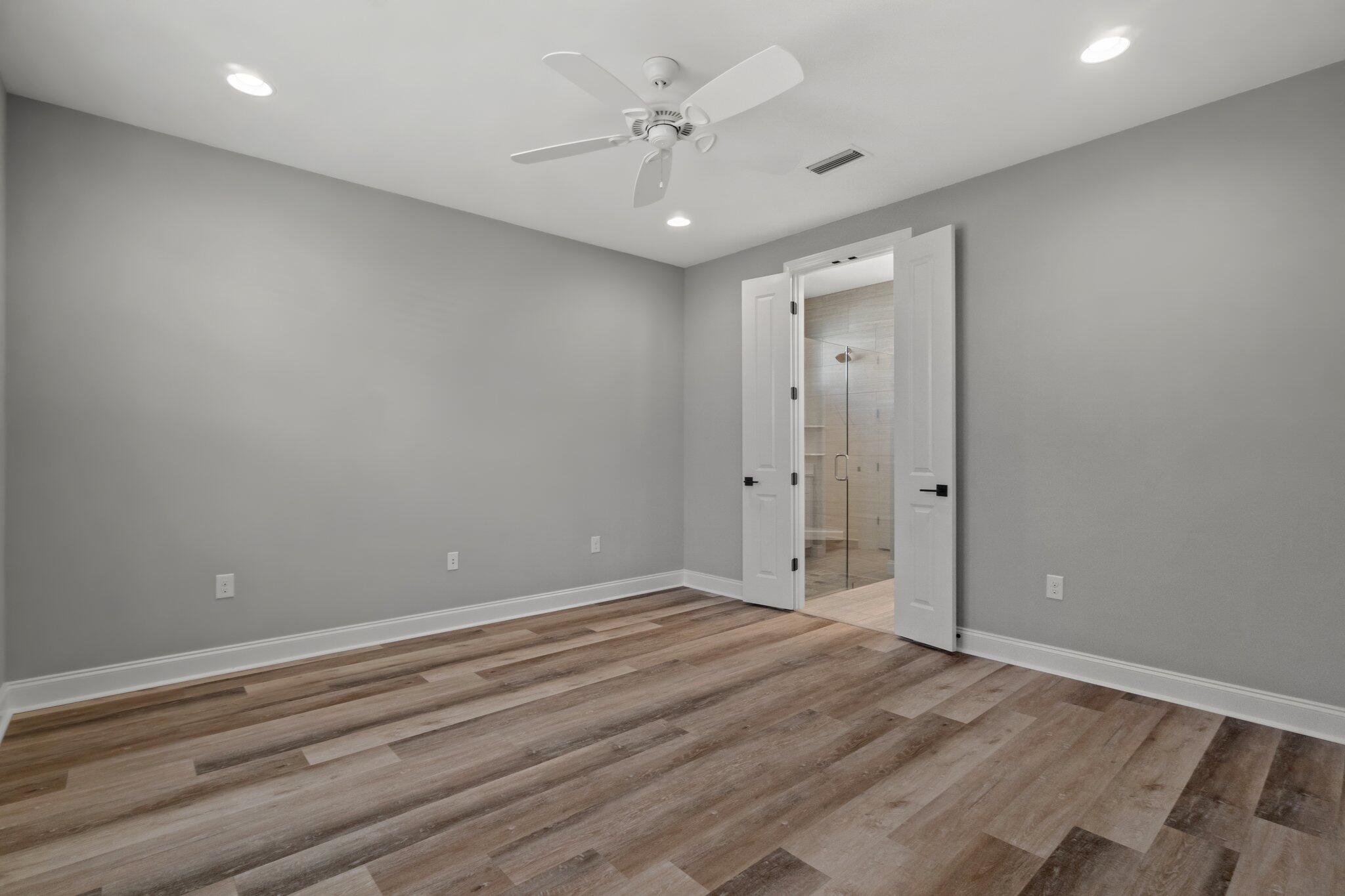 76 Conifer Ct Inlet Beach Inlet Beach, FL 32461 - Photo 8 of 25 wooden floor in an empty room with a ceiling fan