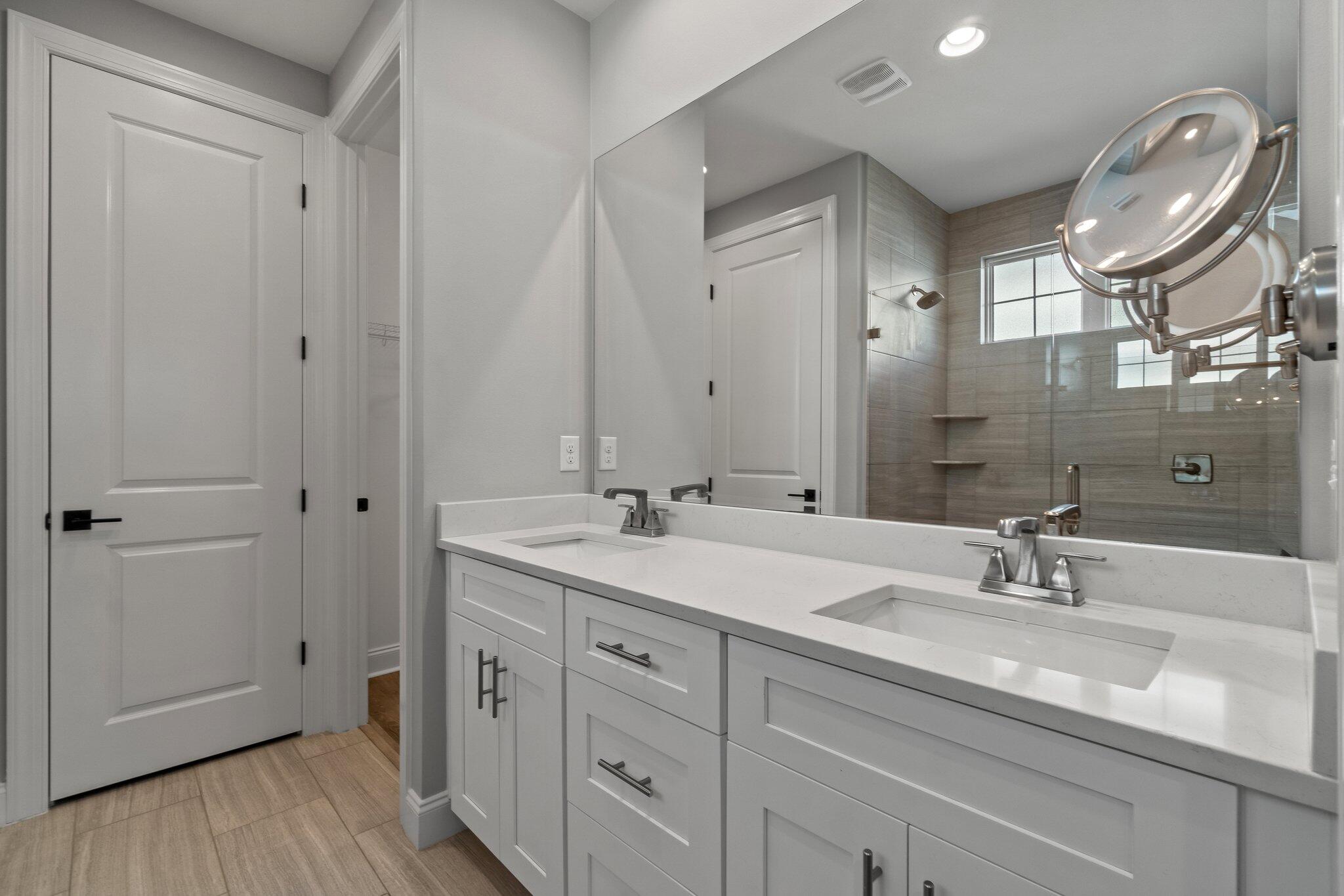 76 Conifer Ct Inlet Beach Inlet Beach, FL 32461 - Photo 9 of 25 a bathroom with a double vanity sink and a mirror
