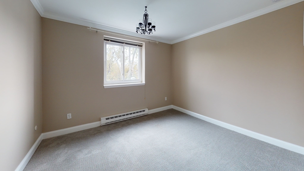 326 Broadway, Unit 21 Somerville, MA 02145 - Photo 2 of 8 an empty room with a window