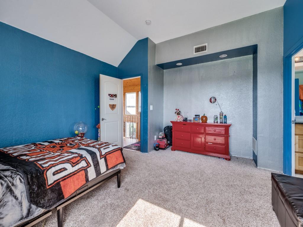 2250 Morrow Road Valley View, TX 76272 - Photo 23 of 35 a bedroom with a bed and a mirror