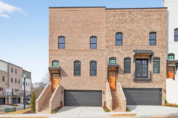 a front view of a house with large windows