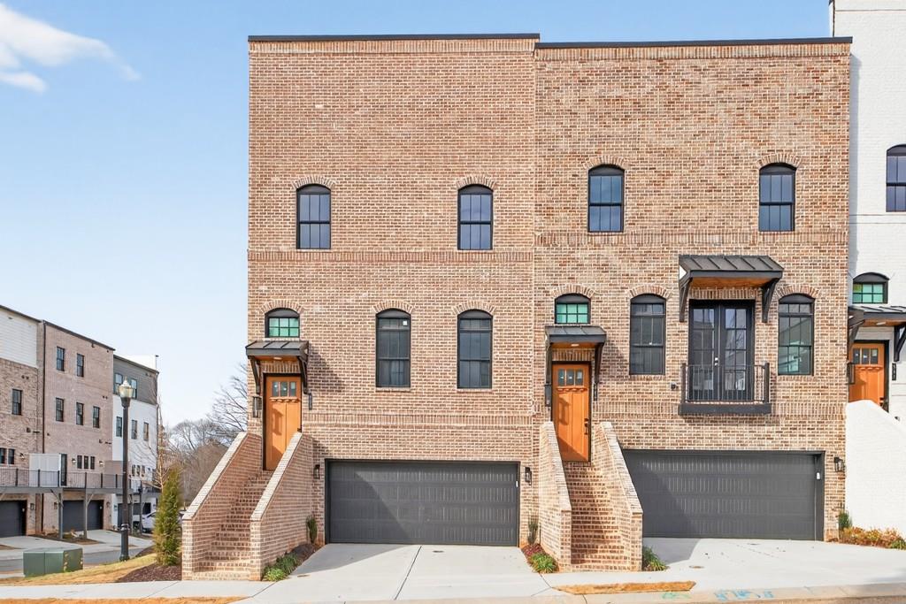 a front view of a house with large windows