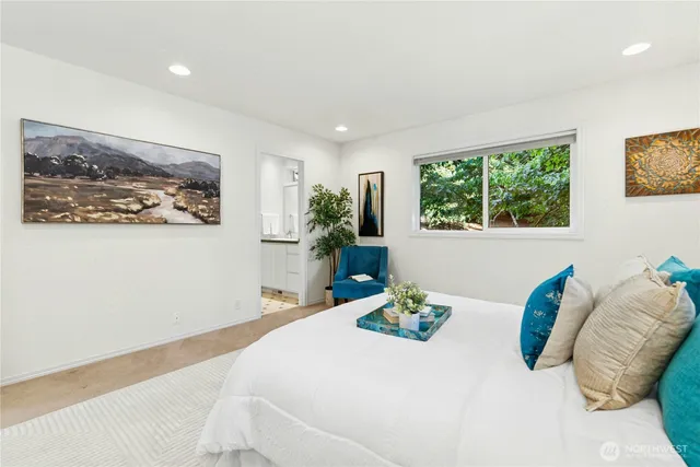 a bedroom with furniture and a large window