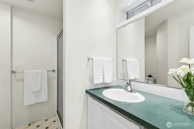 a bathroom with a granite countertop sink and a mirror