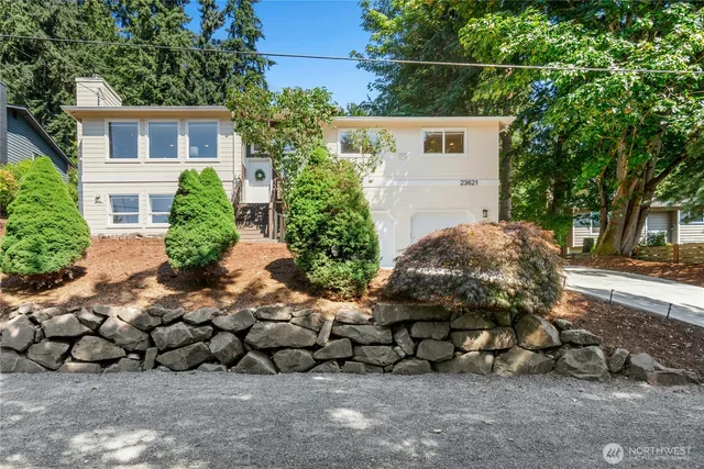 a view of a house with a yard and a garden