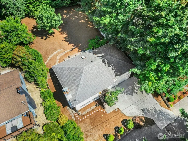 an aerial view of a house with a yard and a outdoor space