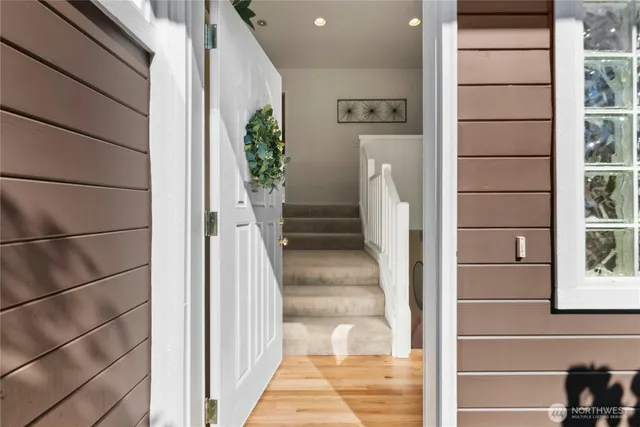 a view of staircase with white walls and windows