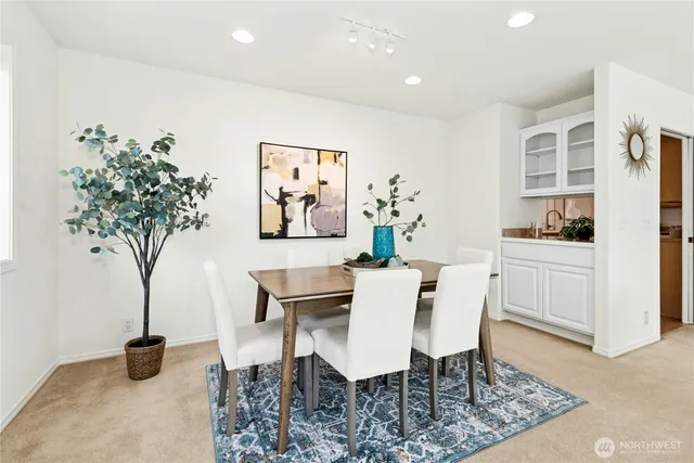 a view of a dining room with furniture and a potted plant