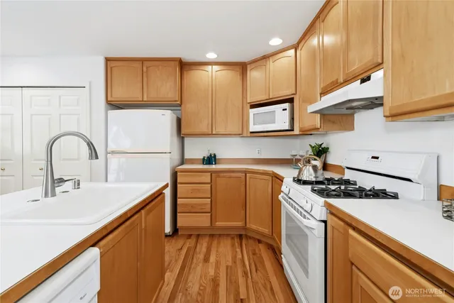 a kitchen with stainless steel appliances a sink stove and cabinets