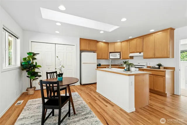 a kitchen with granite countertop white cabinets and stainless steel appliances