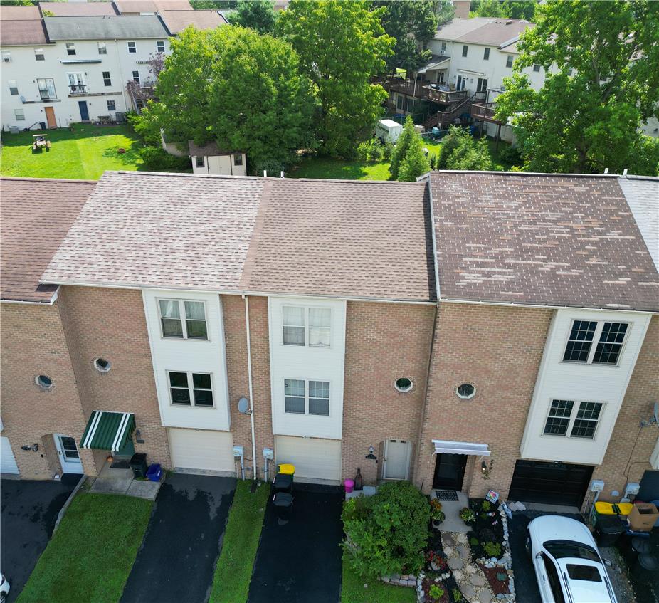 257 Ridgeview Drive Alburtis, PA 18011 - Photo 21 of 24 An aerial perspective reveals a neatly maintained row of townhomes with mature trees.