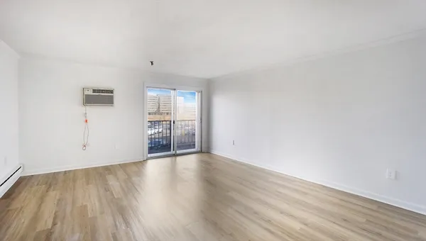 a view of an empty room and wooden floor