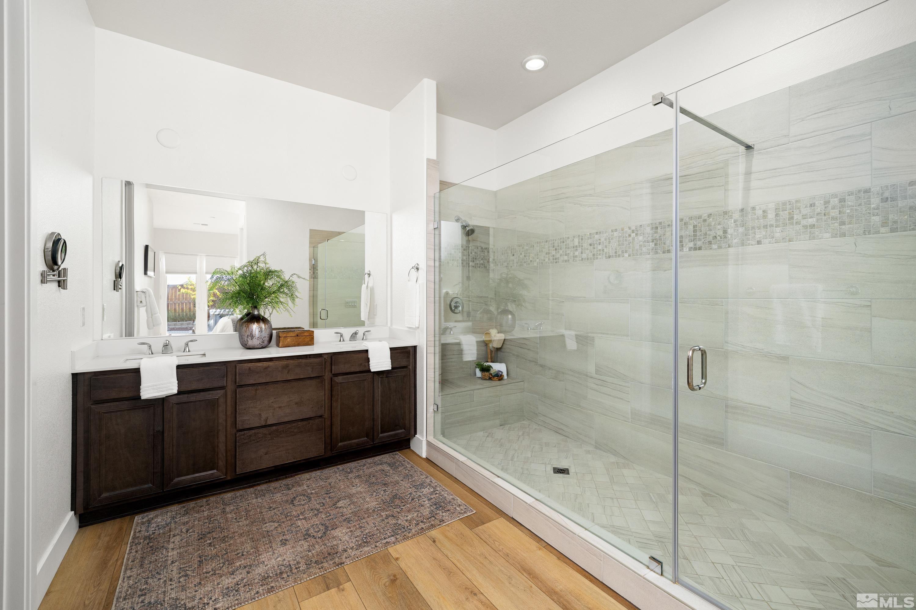 3320 Show Jumper Lane Reno, NV 89521 - Photo 11 of 38 a bathroom with a glass shower door and a sink