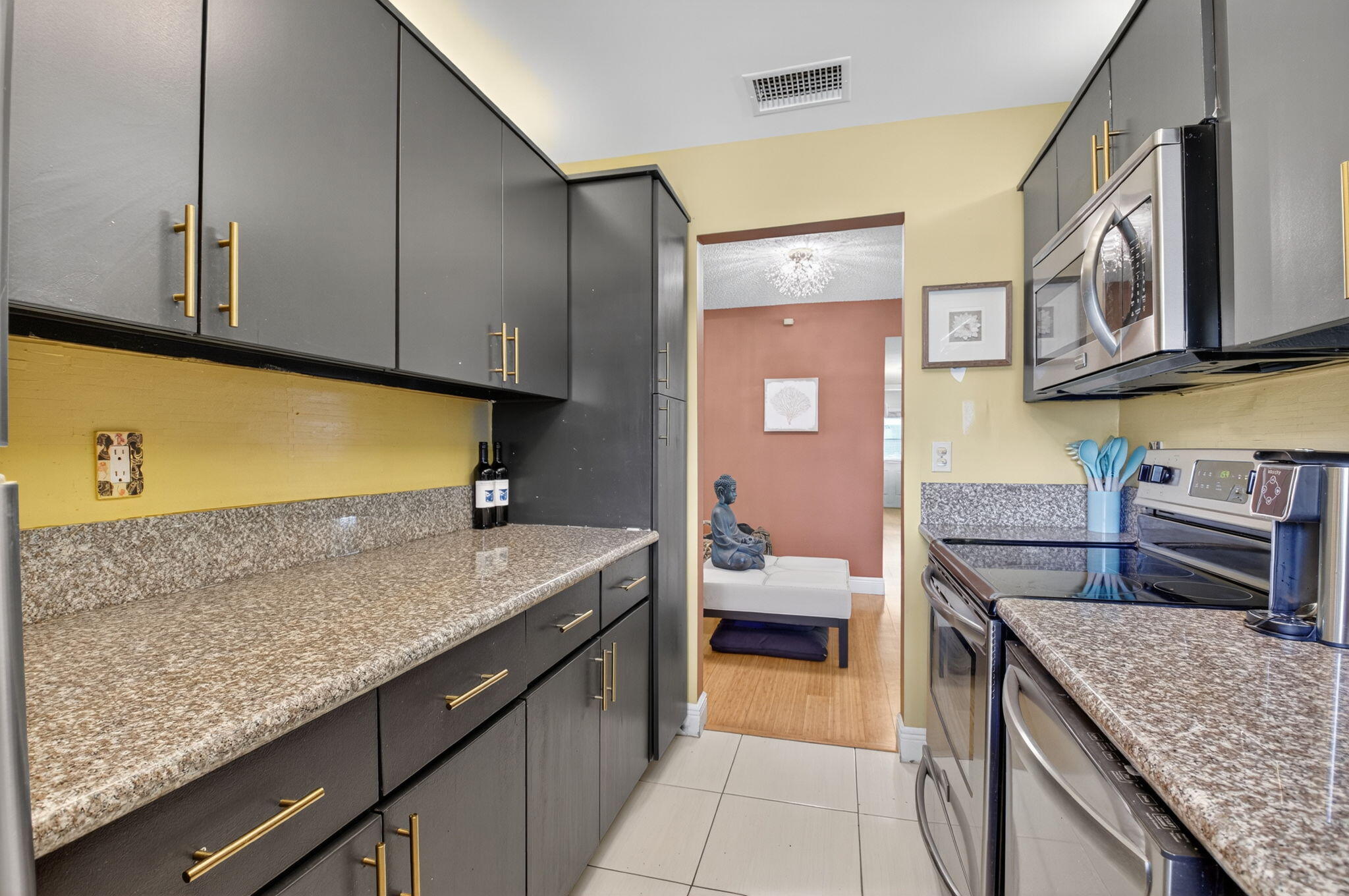 762 High Point Boulevard North, Unit D Delray Beach, FL 33445 - Photo 16 of 32 a kitchen with stainless steel appliances granite countertop a sink and stove