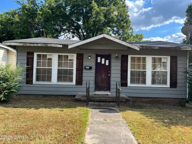 front view of a house with a yard