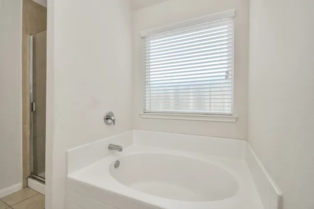 a white bath tub sitting next to a window