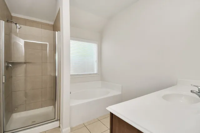 a bathroom with a bathtub and shower