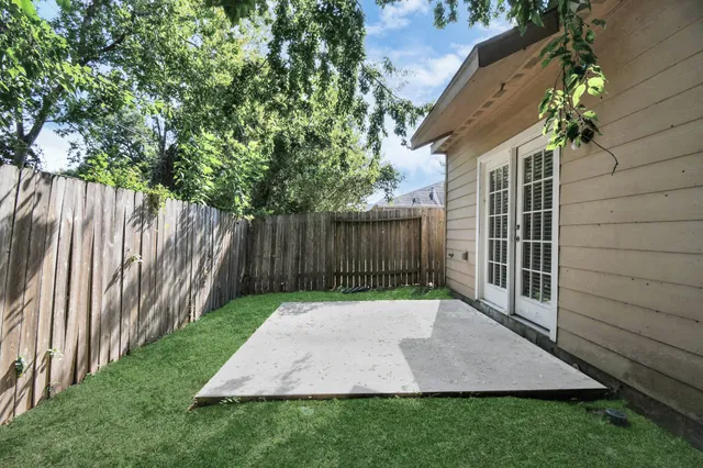 a view of wooden house with a yard