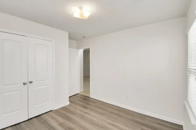 an empty room with wooden floor