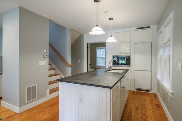 50 Nickerson Drive Barnstable, MA 02635 - Photo 27 of 36 a kitchen with kitchen island a wooden floor and a refrigerator