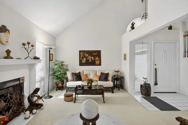 a living room with furniture a dining table and a fireplace