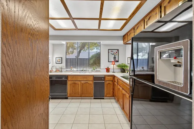 a living room with furniture flowerpot and a chandelier