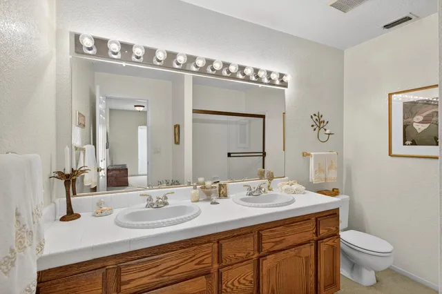 a front view of a house with a yard and plant