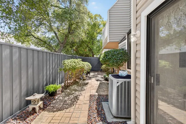 an aerial view of residential houses with outdoor space and trees