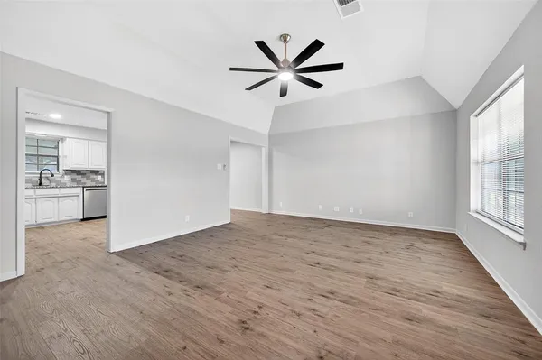 a kitchen with granite countertop white cabinets and white appliances