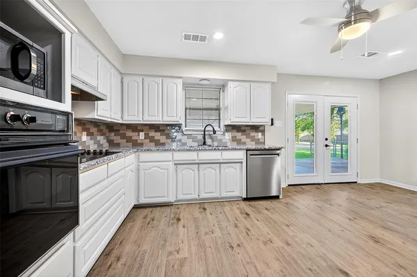 a view of an empty room with wooden floor