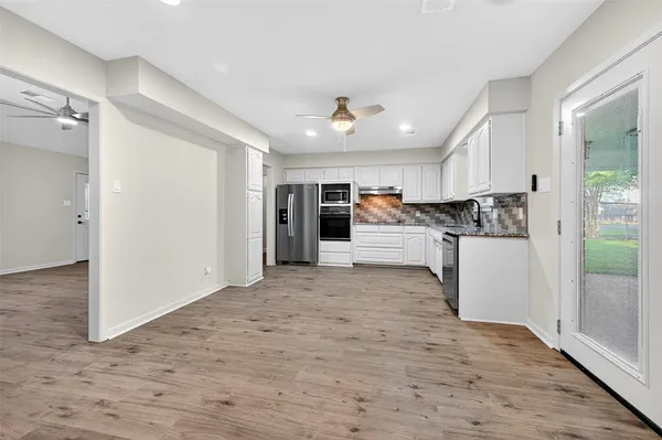 a bathroom with a granite countertop sink a toilet and bathtub