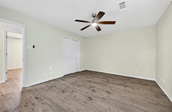 a bathroom with a granite countertop sink a toilet and a mirror