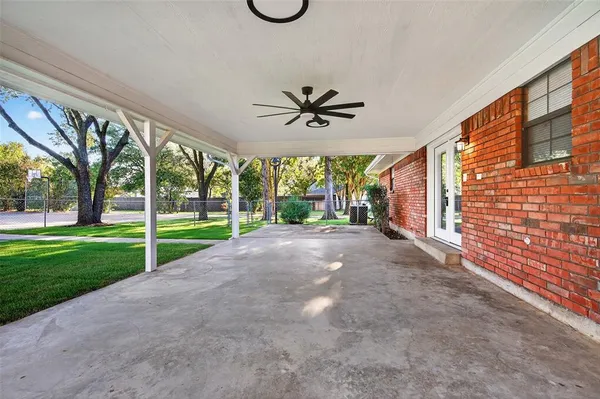 a view of a house with a big yard and a large tree