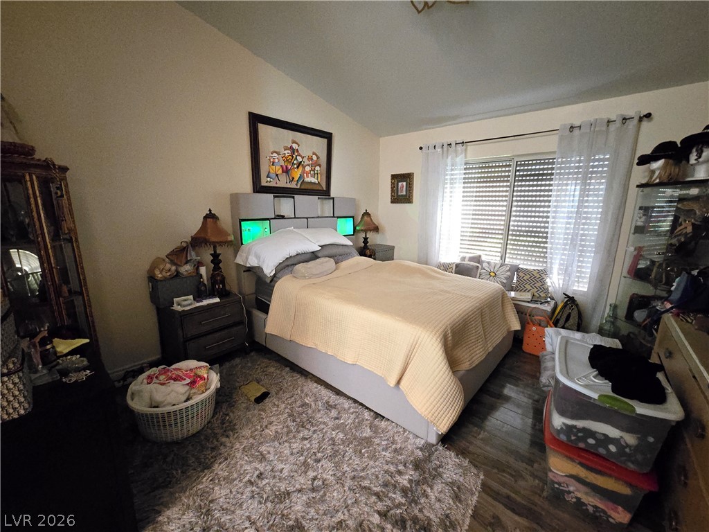 415 Golden State Street Henderson, NV 89012 - Photo 6 of 11 Vaulted ceilings and handsome wood flooring define this inviting bedroom space.