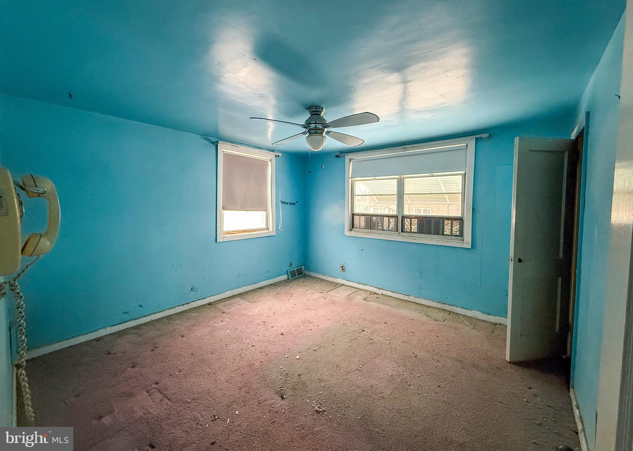 6333 Cottage Street Philadelphia, PA 19135 - Photo 12 of 23 an empty room with windows and fan