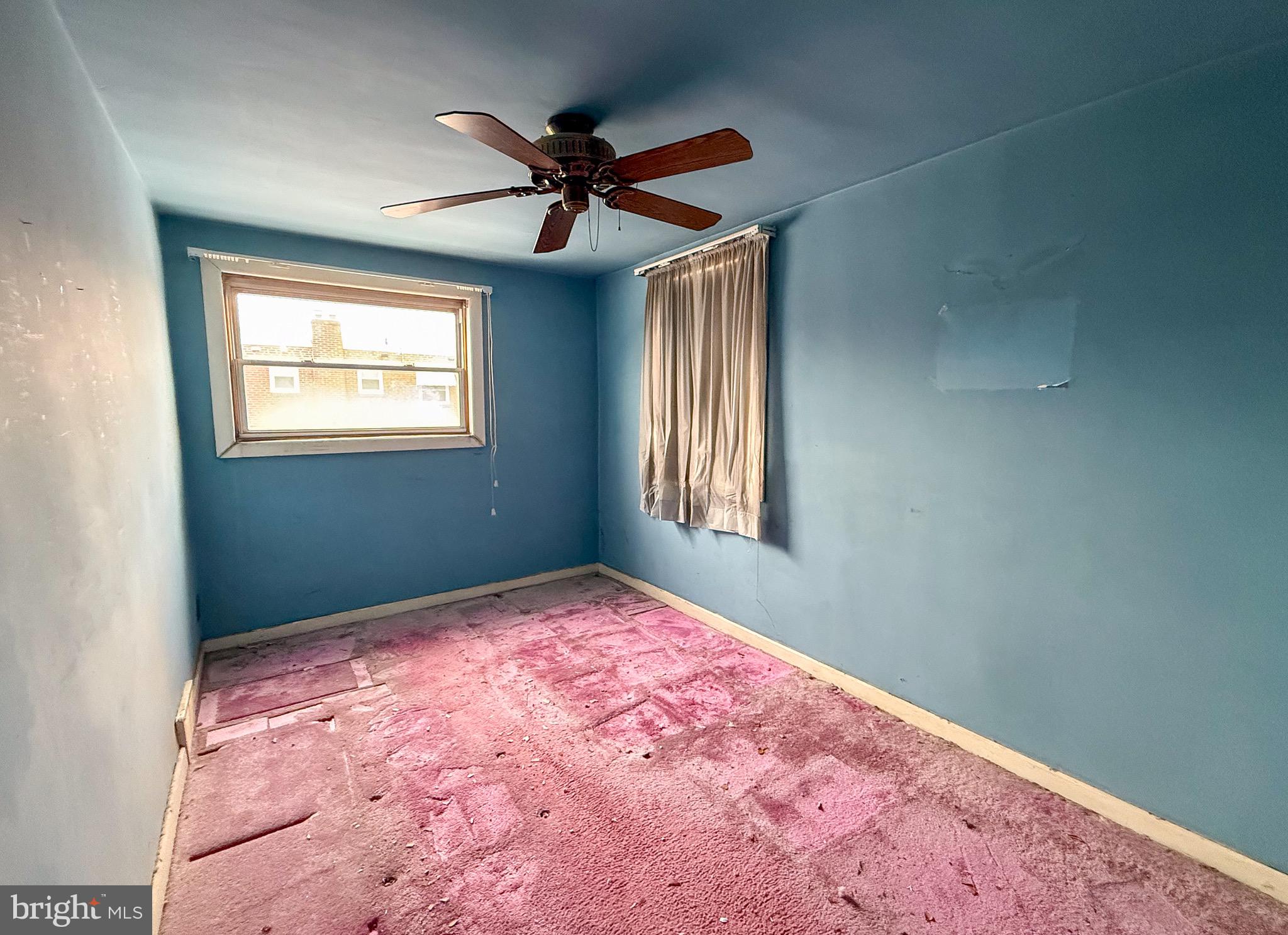 6333 Cottage Street Philadelphia, PA 19135 - Photo 17 of 23 a view of a big room with windows and chandelier fan
