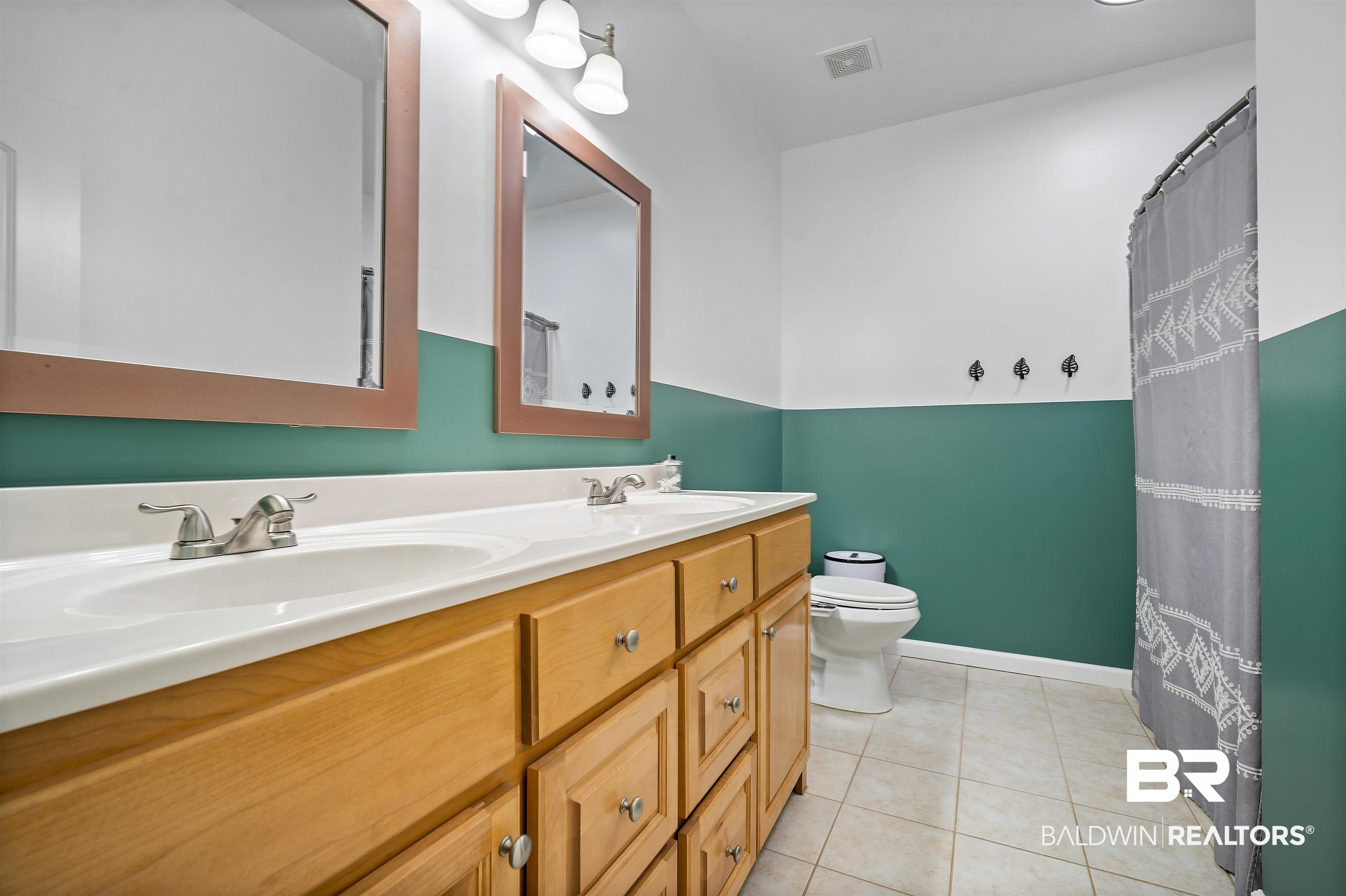 209 Maplewood Loop Daphne, AL 36526 - Photo 14 of 23 Bathroom with double vanity, curtained shower, and light tile patterned floors