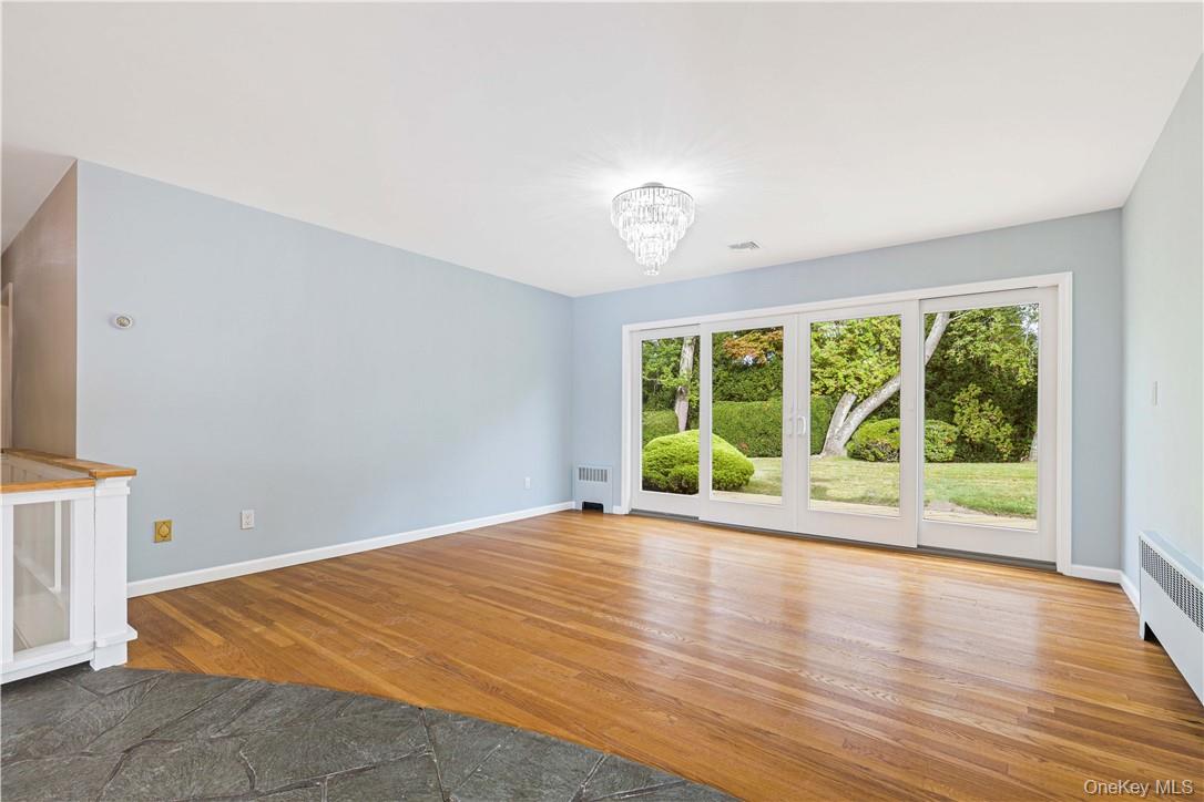 5 Paddock Road Rye Brook, NY 10573 - Photo 5 of 23 Dining room with an inviting chandelier, double sliding doors to deck and level private yard