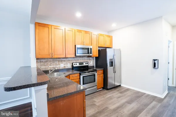 a kitchen with a stove a sink and a microwave