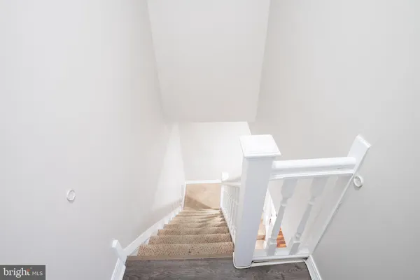 a view of staircase with white walls