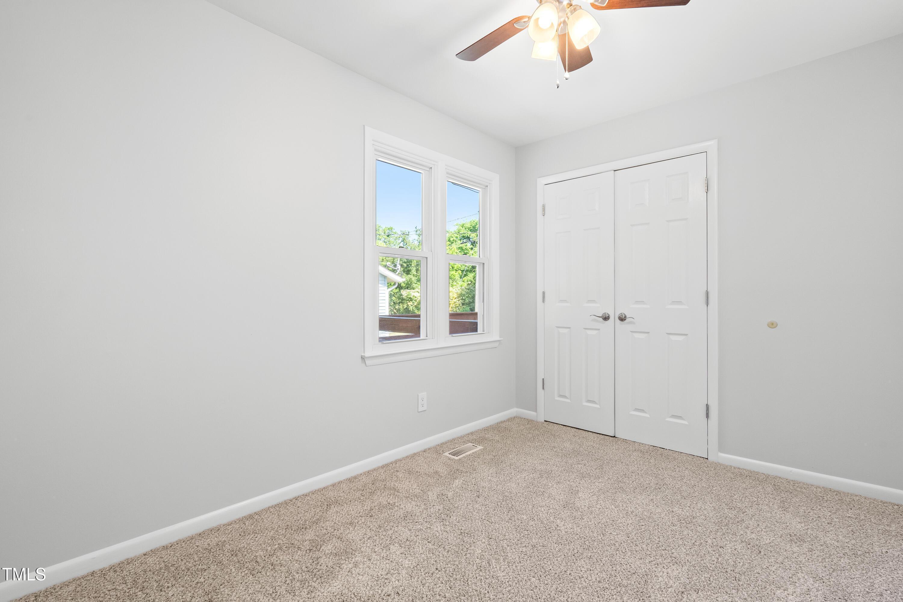 1212 Pender Street Raleigh, NC 27610 - Photo 12 of 19 an empty room with a window and a fan