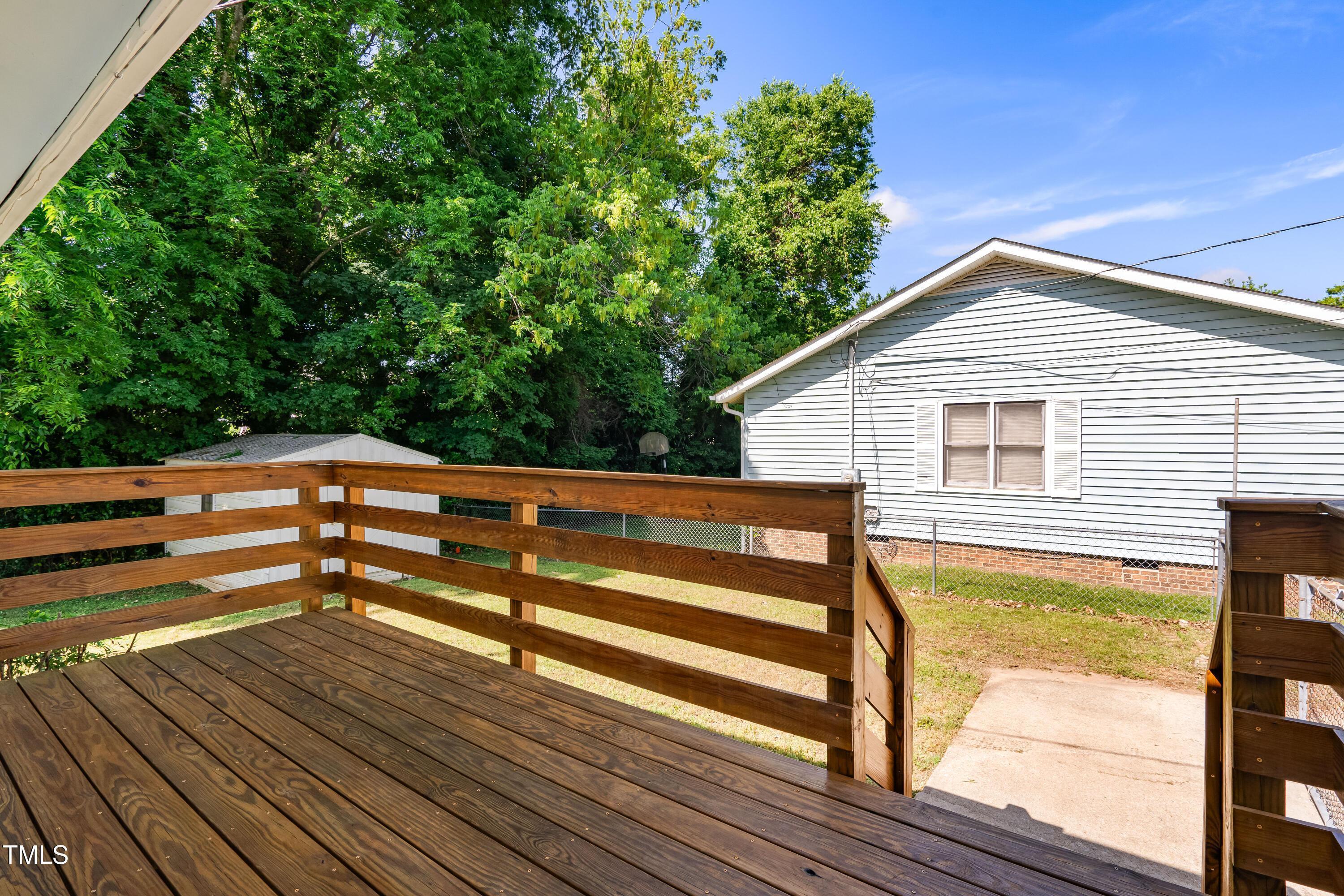 1212 Pender Street Raleigh, NC 27610 - Photo 14 of 19 a backyard of a house with wooden floor and outdoor seating