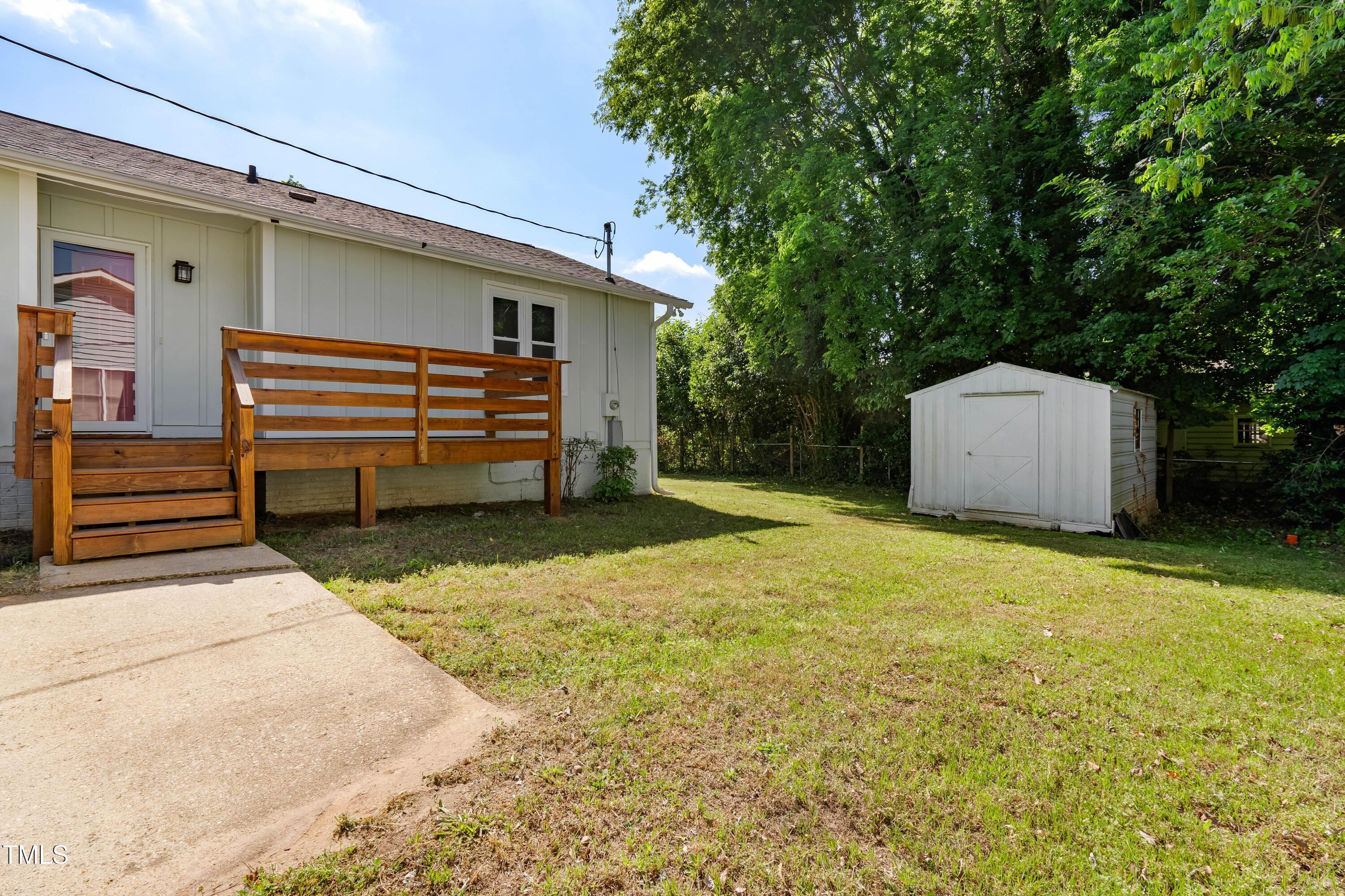 1212 Pender Street Raleigh, NC 27610 - Photo 15 of 19 a backyard of a house with a large tree and wooden fence