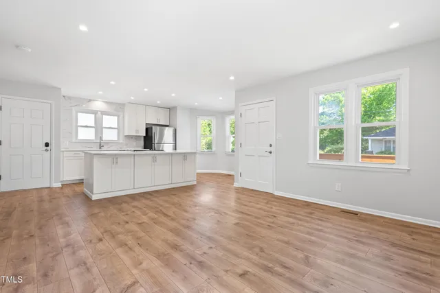 a view of a kitchen with an empty space and a window