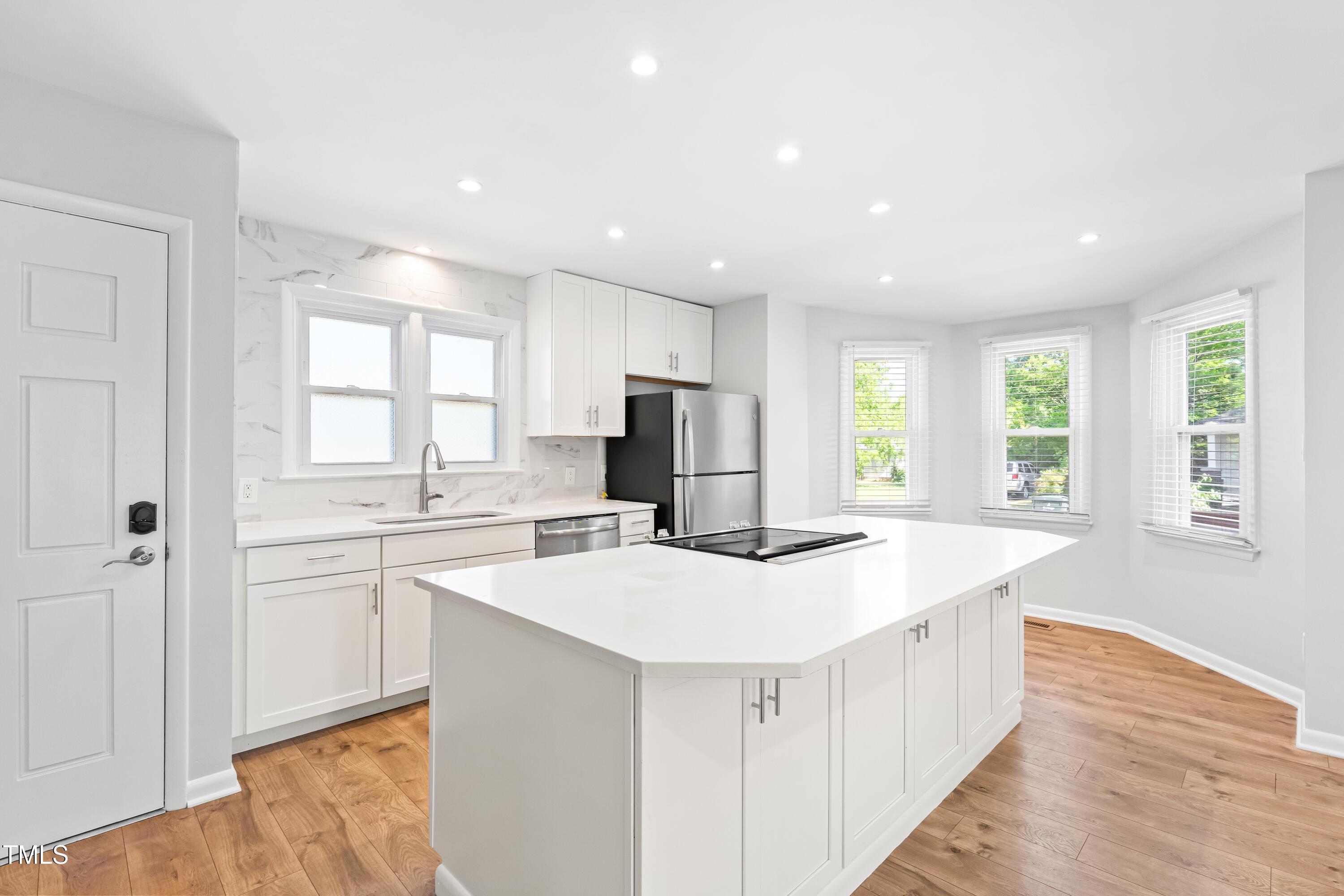1212 Pender Street Raleigh, NC 27610 - Photo 6 of 19 a kitchen with stainless steel appliances a sink stove and cabinets