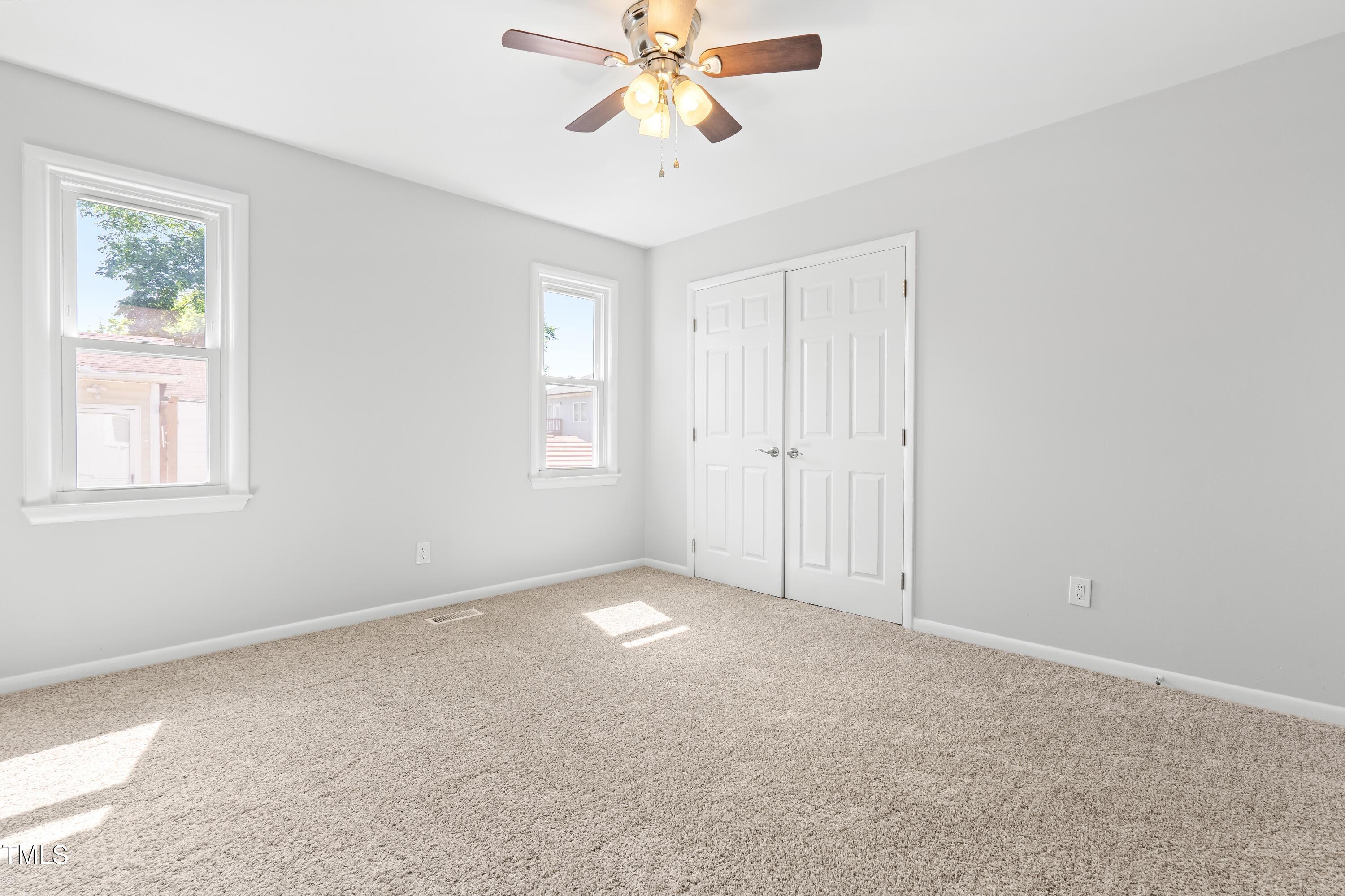 1212 Pender Street Raleigh, NC 27610 - Photo 10 of 19 an empty room with windows and fan