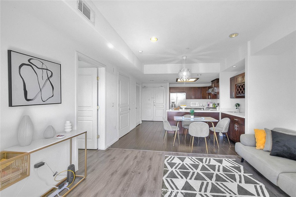 11 South 3rd Street, Unit 226 Alhambra, CA 91801 - Photo 11 of 25 a living room with furniture a rug and kitchen view