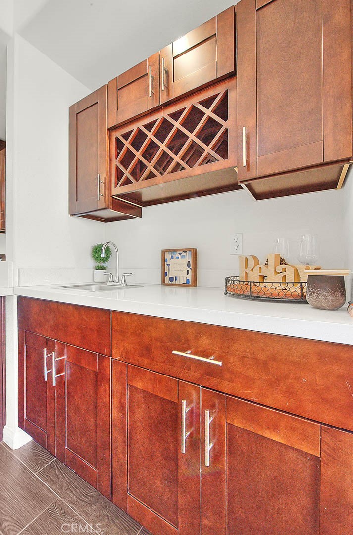 11 South 3rd Street, Unit 226 Alhambra, CA 91801 - Photo 16 of 25 a kitchen with stainless steel appliances granite countertop a sink dishwasher cabinets and couches with wooden floor