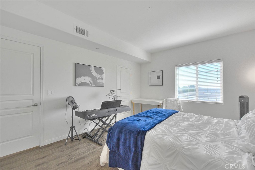 11 South 3rd Street, Unit 226 Alhambra, CA 91801 - Photo 18 of 25 a spacious bedroom with a bed and a table in it